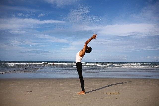 Streatching yoga pose on beach