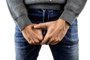man holding groin region