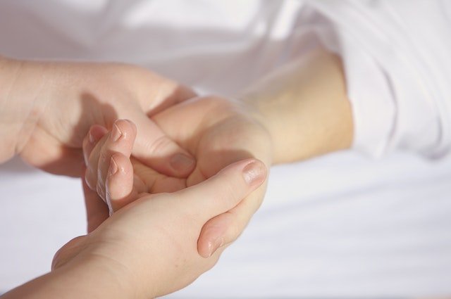 EFT Practitioner holding clients hand